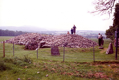 Corrimony cairn with visitors